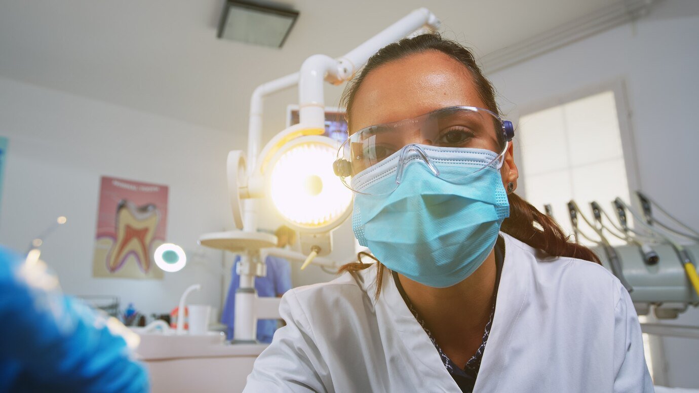 A picture of a dentist wearing a musk 